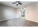 Spacious living room featuring neutral paint, plush carpet, and a ceiling fan at 2625 Cattrack Ave, North Las Vegas, NV 89081