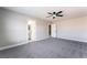 This main bedroom features gray carpet, a ceiling fan, and an ensuite bathroom entrance at 2625 Cattrack Ave, North Las Vegas, NV 89081