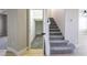 Carpeted staircase with an adjacent closet and wood-look floors at 2625 Cattrack Ave, North Las Vegas, NV 89081