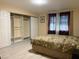 Spacious bedroom showcases a bed, closet organizers, laminate floors and neutral colors at 2701 Beaver Creek Ct # 201, Las Vegas, NV 89117