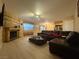 Open living room featuring laminate floors, brick fireplace, and modern furnishings at 2701 Beaver Creek Ct # 201, Las Vegas, NV 89117