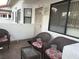 Cozy patio with three cushioned wicker chairs, glass table and outdoor seating area at 2701 Beaver Creek Ct # 201, Las Vegas, NV 89117