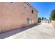 Exterior home view with a spacious concrete area leading to a storage shed, complemented by desert landscaping at 2728 Aspen Wood Ave, Henderson, NV 89074
