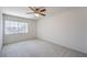Bright, carpeted bedroom with a ceiling fan and a large window offering neighborhood views at 2728 Aspen Wood Ave, Henderson, NV 89074