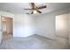 Bright bedroom features neutral carpet, ceiling fan, and easy access to an ensuite bathroom and closet at 2728 Aspen Wood Ave, Henderson, NV 89074