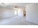 Spacious bedroom with a ceiling fan, neutral carpet, and a view into an adjacent bathroom at 2728 Aspen Wood Ave, Henderson, NV 89074