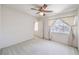 Bedroom featuring soft carpet, a ceiling fan, and a window with light-filtering curtains at 2728 Aspen Wood Ave, Henderson, NV 89074