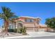 Charming two-story home with a three-car garage, desert landscaping, and a mature palm tree at 2728 Aspen Wood Ave, Henderson, NV 89074
