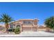 Charming two-story home with a three-car garage, desert landscaping, and a mature palm tree at 2728 Aspen Wood Ave, Henderson, NV 89074