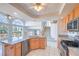 Open concept kitchen with island, stainless steel appliances, and backyard views at 2728 Aspen Wood Ave, Henderson, NV 89074
