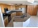 Spacious kitchen featuring an island, stainless appliances, and tile floors at 2728 Aspen Wood Ave, Henderson, NV 89074