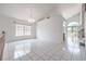 Bright living room with tile floors, stairs, large windows, and a view into the kitchen at 2728 Aspen Wood Ave, Henderson, NV 89074