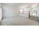Bright living room featuring new carpet, stairs to the second story, and a large window at 2728 Aspen Wood Ave, Henderson, NV 89074