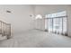 Spacious living room with high ceilings, large windows, and neutral carpeting at 2728 Aspen Wood Ave, Henderson, NV 89074