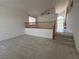 Cozy living room with vaulted ceiling, stairs, and neutral carpeting at 2728 Aspen Wood Ave, Henderson, NV 89074