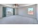 Large primary bedroom with a ceiling fan and large windows filling the space with light at 2728 Aspen Wood Ave, Henderson, NV 89074