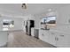 Modern kitchen with stainless steel appliances and a view into the living area at 3115 Floral Vista Ave, Henderson, NV 89014