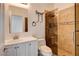 Bathroom featuring a tiled shower with glass door and a vanity with mirror at 3200 Ridgecliff St, Las Vegas, NV 89129