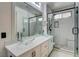 Stylish bathroom with dual glass vessel sinks, white cabinets, and walk in shower at 3200 Ridgecliff St, Las Vegas, NV 89129