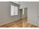 Bright bedroom featuring hardwood floors, a window with blinds, and a mirrored closet at 3200 Ridgecliff St, Las Vegas, NV 89129