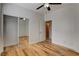 Bedroom with hardwood floors, ceiling fan, mirrored closet, and an open doorway at 3200 Ridgecliff St, Las Vegas, NV 89129