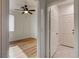 A bedroom with light wood flooring, a ceiling fan, and a window with blinds at 3200 Ridgecliff St, Las Vegas, NV 89129