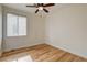 Bedroom features wood floors, a ceiling fan, and a large window with blinds at 3200 Ridgecliff St, Las Vegas, NV 89129