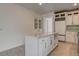 Bright kitchen with white cabinetry, a center island, stainless steel appliances, and tile backsplash at 3200 Ridgecliff St, Las Vegas, NV 89129