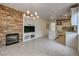 Bright open-concept living room with fireplace, built-in shelves, tile floors, and adjoining kitchen at 3200 Ridgecliff St, Las Vegas, NV 89129