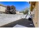 Fenced backyard with stone ground cover and trees for a secure and private outdoor area at 3905 Sweet Pine St # 102, Las Vegas, NV 89108