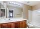 Bright bathroom featuring a vanity with a large mirror, tile flooring, and a shower-tub combo, offering a clean and functional space at 3905 Sweet Pine St # 102, Las Vegas, NV 89108