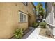 Side view of townhome featuring manicured landscaping, walkway, and neutral color at 3905 Sweet Pine St # 102, Las Vegas, NV 89108