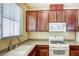 Well-lit kitchen showcases wooden cabinets and countertops, equipped with modern appliances and a large sink under a bright window at 3905 Sweet Pine St # 102, Las Vegas, NV 89108