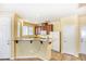 Bright kitchen with modern appliances, breakfast bar, tile flooring, and an adjacent door to the outside at 3905 Sweet Pine St # 102, Las Vegas, NV 89108