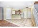 Open kitchen featuring modern appliances, a breakfast bar, and easy access to living spaces and stairway at 3905 Sweet Pine St # 102, Las Vegas, NV 89108