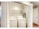 Laundry closet with washer, dryer, and overhead shelving for convenient laundry solutions at 3905 Sweet Pine St # 102, Las Vegas, NV 89108