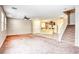 Open-concept home with plush carpet, tile floor and ceiling fan offers seamless transition to the kitchen and stairwell at 3905 Sweet Pine St # 102, Las Vegas, NV 89108