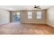 Spacious living room featuring neutral walls, plush carpet and a sliding glass door to the outdoor area at 3905 Sweet Pine St # 102, Las Vegas, NV 89108