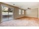 Neutral living room featuring sliding door access to the backyard and natural light from large windows at 3905 Sweet Pine St # 102, Las Vegas, NV 89108