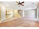Bright open-concept living space, featuring plush carpet, a ceiling fan and direct access to kitchen and stairway at 3905 Sweet Pine St # 102, Las Vegas, NV 89108