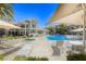 Community pool with hot tub and lounge chairs, surrounded by palm trees and umbrellas for a relaxing outdoor experience at 3905 Sweet Pine St # 102, Las Vegas, NV 89108