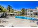 Resort-style pool surrounded by mature palm trees, lounge seating, and umbrellas perfect for relaxation at 3905 Sweet Pine St # 102, Las Vegas, NV 89108