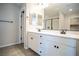 Bathroom featuring double vanity, large mirror, and walk-in shower at 3922 Painted Lady Ave, Las Vegas, NV 89141