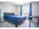 Cozy bedroom with carpet, natural light, and blue bedding at 3922 Painted Lady Ave, Las Vegas, NV 89141