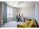 Bedroom with desk, sofa, and large window bringing in lots of natural light at 3922 Painted Lady Ave, Las Vegas, NV 89141