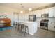 Modern kitchen with white cabinets, stainless steel appliances, and a large island at 3922 Painted Lady Ave, Las Vegas, NV 89141