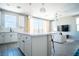 Open-concept kitchen with stainless appliances and island extending to the living room at 3922 Painted Lady Ave, Las Vegas, NV 89141