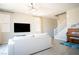 Comfortable living room with a piano, modern lighting, and tile floors at 3922 Painted Lady Ave, Las Vegas, NV 89141