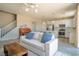 Cozy living room featuring a sofa and a view of the open-concept kitchen at 3922 Painted Lady Ave, Las Vegas, NV 89141