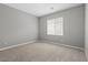 Cozy bedroom with plush carpeting and a sun-filled window, perfect for relaxing at 4404 Cave Lake Ave, North Las Vegas, NV 89032